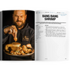 Open cookbook showing a recipe for 'Bang Bang Shrimp' with a person adding sauce to food.